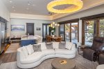 The open concept living area is embellished with custom lighting.